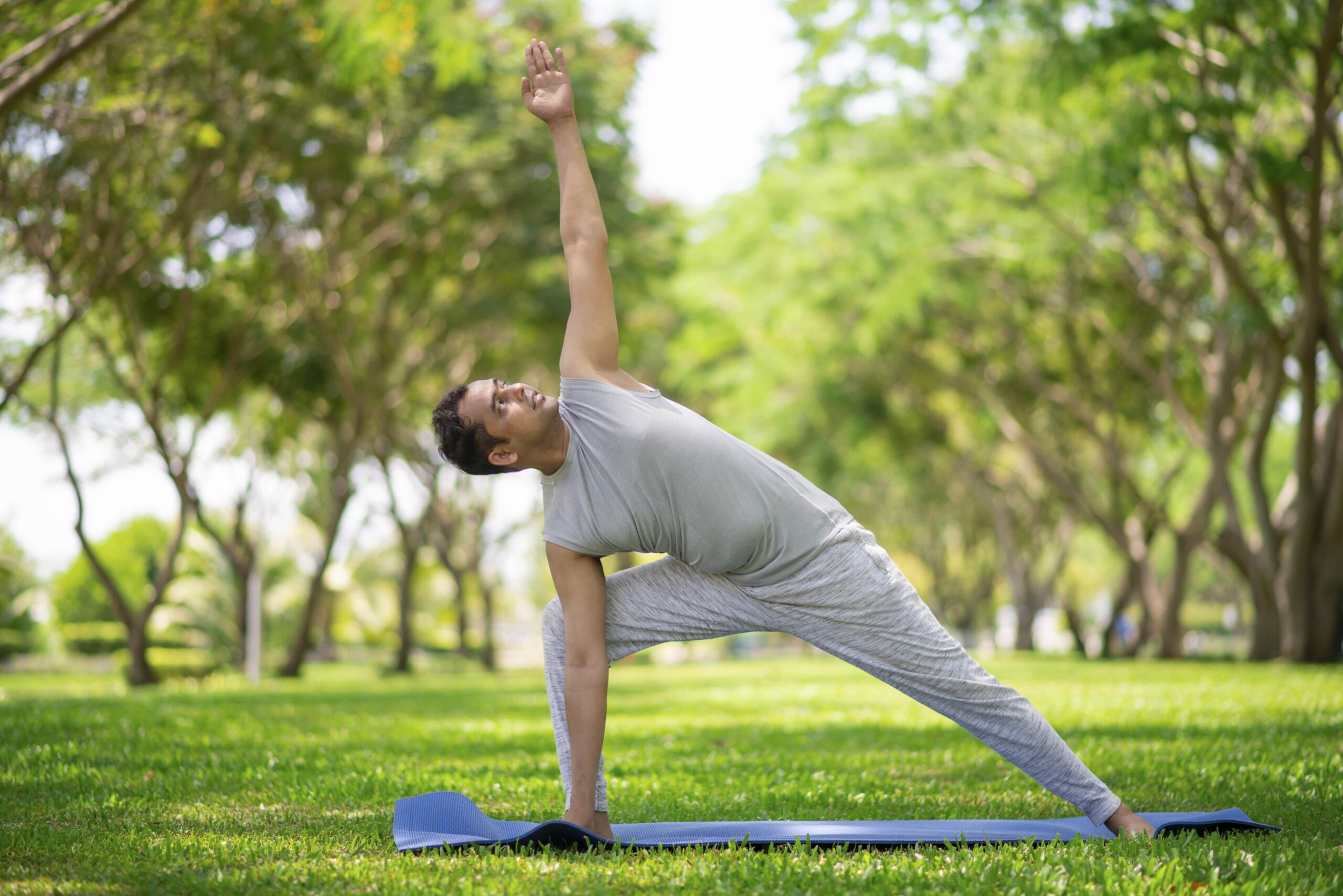 inspired-indian-man-doing-yoga-asanas-city-park-young-citizen-exercising-outside-min